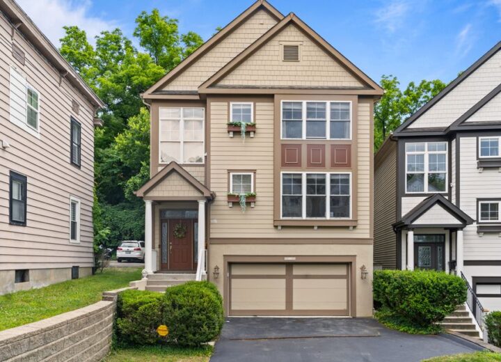 Front view of a modern suburban home in Cincinnati, Ohio with a garage and garden.
