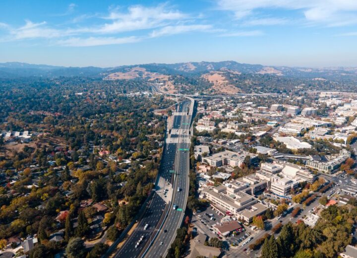 Aerial view capturing the sprawling suburbs and highway of Walnut Creek, California