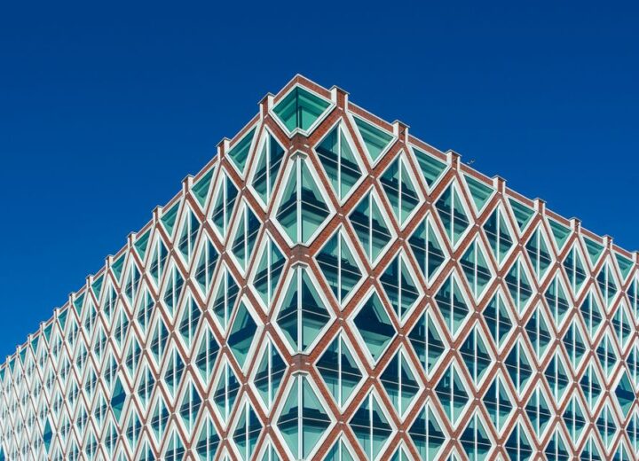 Elegant modern architecture in Gouda, featuring geometric design and vivid blue sky.
