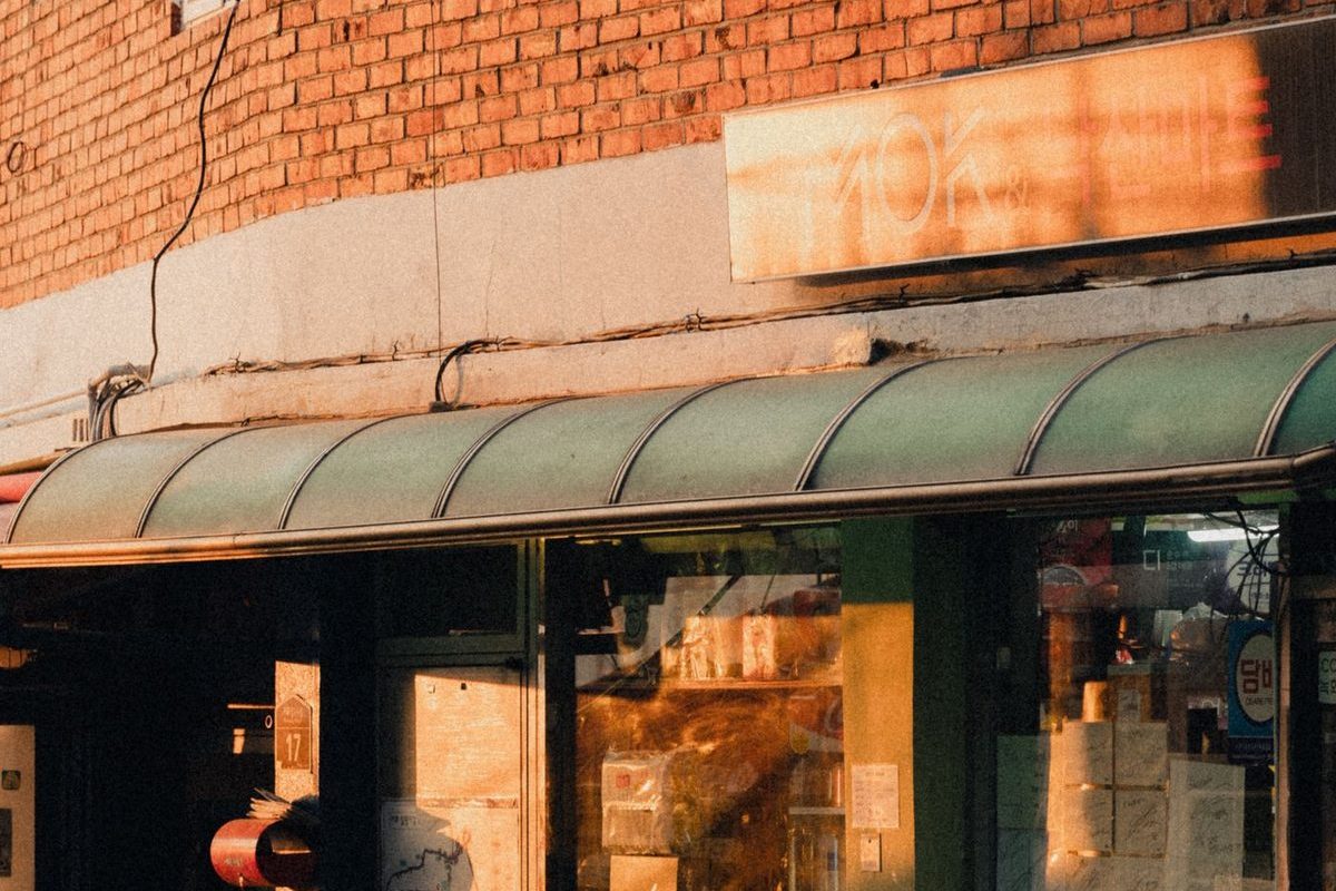 A brick building storefront at sunset