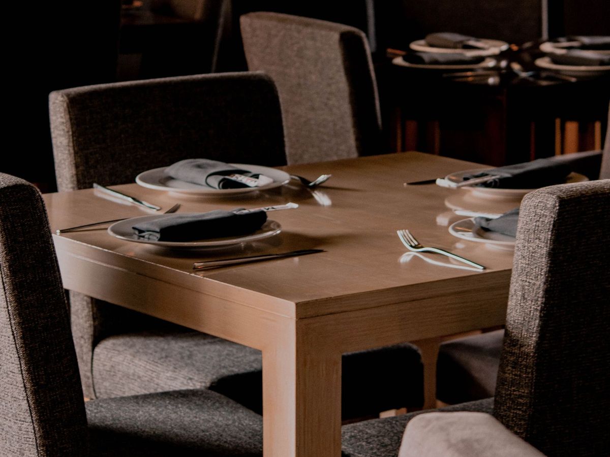 Set tables and upholstered chairs in a quiet restaurant dining room